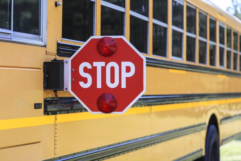 Photo of a school bus with its stop sign deployed