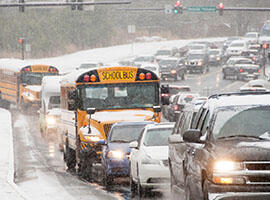 School buses driving in the snow